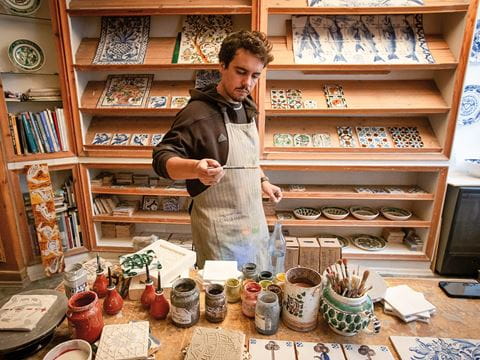 Third-generation tilemaker Miguel Moura works on a Moorish tile design at his workshop in Lisbon.