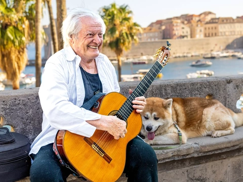 Singer-songwriter Ibrica Jusić, with his dog Simba, is a sevdalinka fixture in the Old Town of Dubrovnik, Croatia, on the coast of the Adriatic Sea.